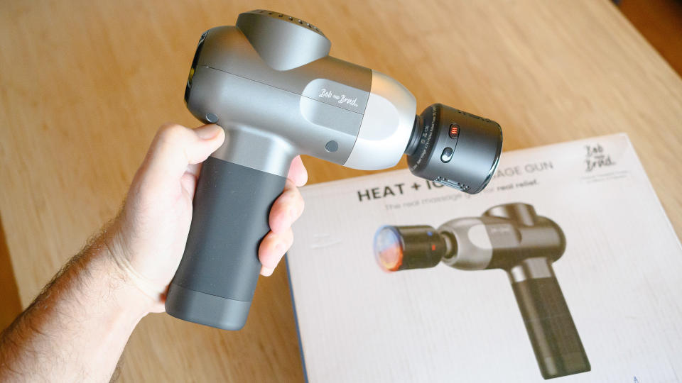 Person holding the Bob and Brad C2 Pro Heat and Ice Massage Gun