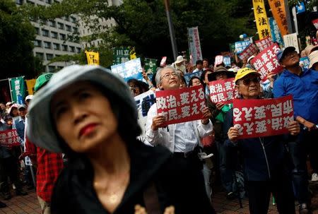 People rally during a protest denouncing the policies of Japanese Prime Minister Shinzo Abe in Tokyo, Japan, June 5, 2016. The placards read: "Citizen change politics." REUTERS/Thomas Peter