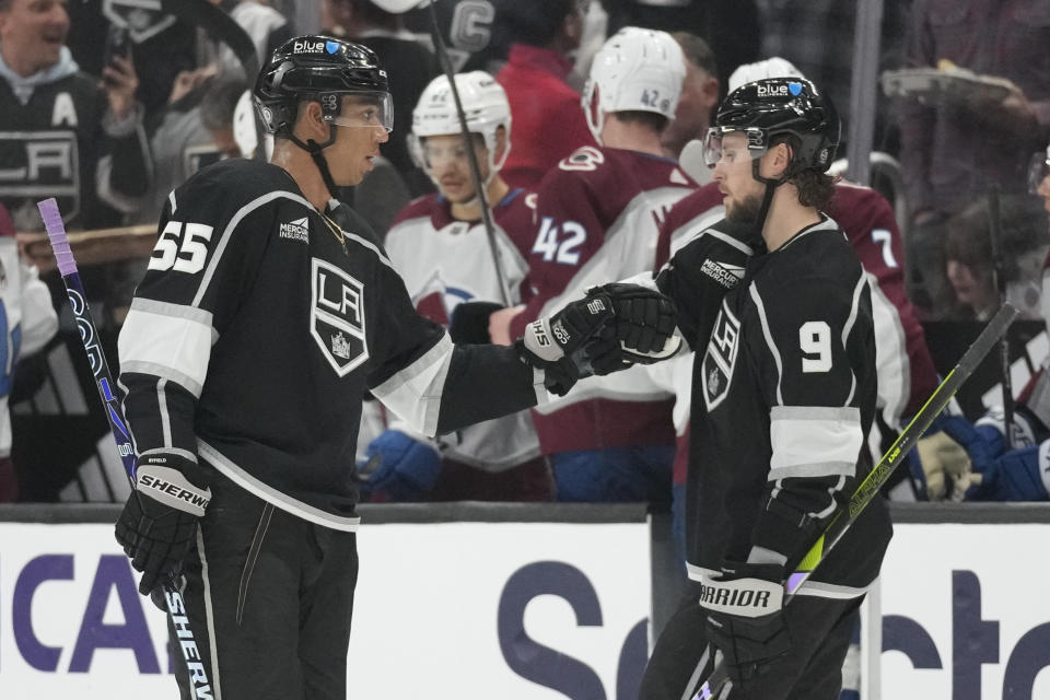 Los Angeles Kings center Quinton Byfield (55) celebrates with center Adrian Kempe (9) after scoring during the second period of an NHL hockey against the Colorado Avalanche game Sunday, Dec. 3, 2023, in Los Angeles. (AP Photo/Ashley Landis)