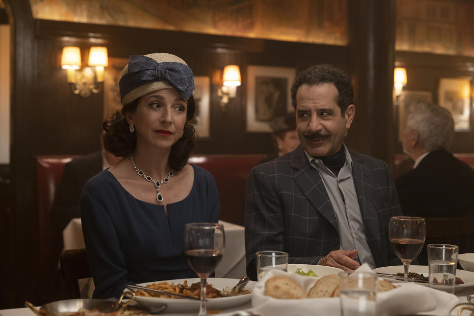 A man and woman sitting at a restaurant table in 1960s clothing; still from "The Marvelous Mrs. Maisel"