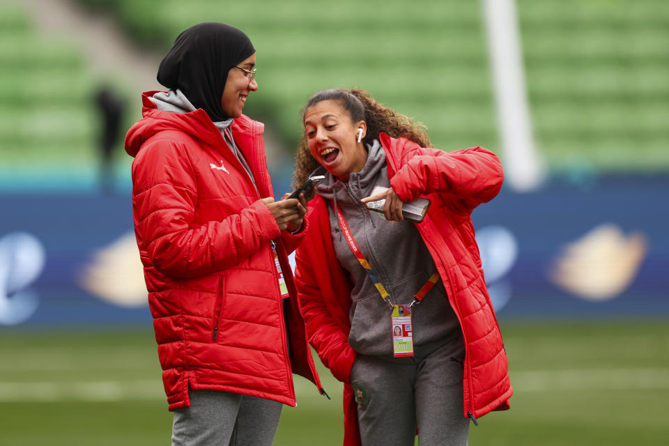 Morocco's Nouhaila Benzina, left, and Fatima Gharbi walk around the ground during a familiarization tour ahead of their Women's World Cup Group H match against Germany in Melbourne, Australia, Sunday, July 23, 2023. When Benzina steps onto the pitch Monday evening, she will be first player to compete in a senior-level FIFA Women's World Cup wearing a hijab. (AP Photo/Victoria Adkins)