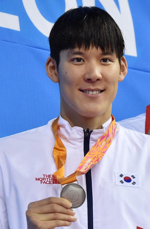 South Korea's Park Tae-Hwan stands on the podium with his silver medal after the men's 100m freestyle swimming event during the 17th Asian Games in Incheon, on September 25, 2014