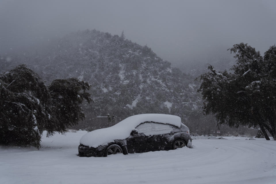 A car covered in snow during a storm in Mount Baldy, California, US, on Friday, Feb. 24, 2023. / Credit: Getty/Bloomberg