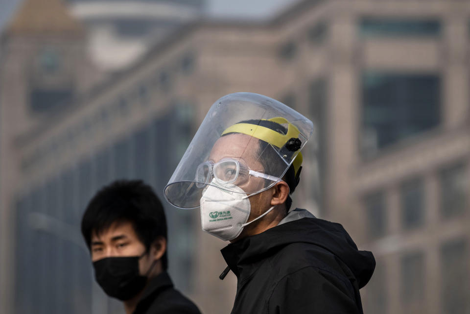 BEIJING, CHINA - FEBRUARY 12: Chinese men wear protective masks as they walk on February 12, 2020 in Beijing, China. The number of cases of a deadly new coronavirus rose to more than 44000 in mainland China Wednesday, days after the World Health Organization (WHO) declared the outbreak a global public health emergency. China continued to lock down the city of Wuhan in an effort to contain the spread of the pneumonia-like disease which medicals experts have confirmed can be passed from human to human. In an unprecedented move, Chinese authorities have put travel restrictions on the city which is the epicentre of the virus and municipalities in other parts of the country affecting tens of millions of people. The number of those who have died from the virus in China climbed to over 1100 on Thursday, mostly in Hubei province, and cases have been reported in other countries including the United States, Canada, Australia, Japan, South Korea, India, the United Kingdom, Germany, France and several others. The World Health Organization has warned all governments to be on alert and screening has been stepped up at airports around the world. Some countries, including the United States, have put restrictions on Chinese travelers entering and advised their citizens against travel to China. (Photo by Kevin Frayer/Getty Images)