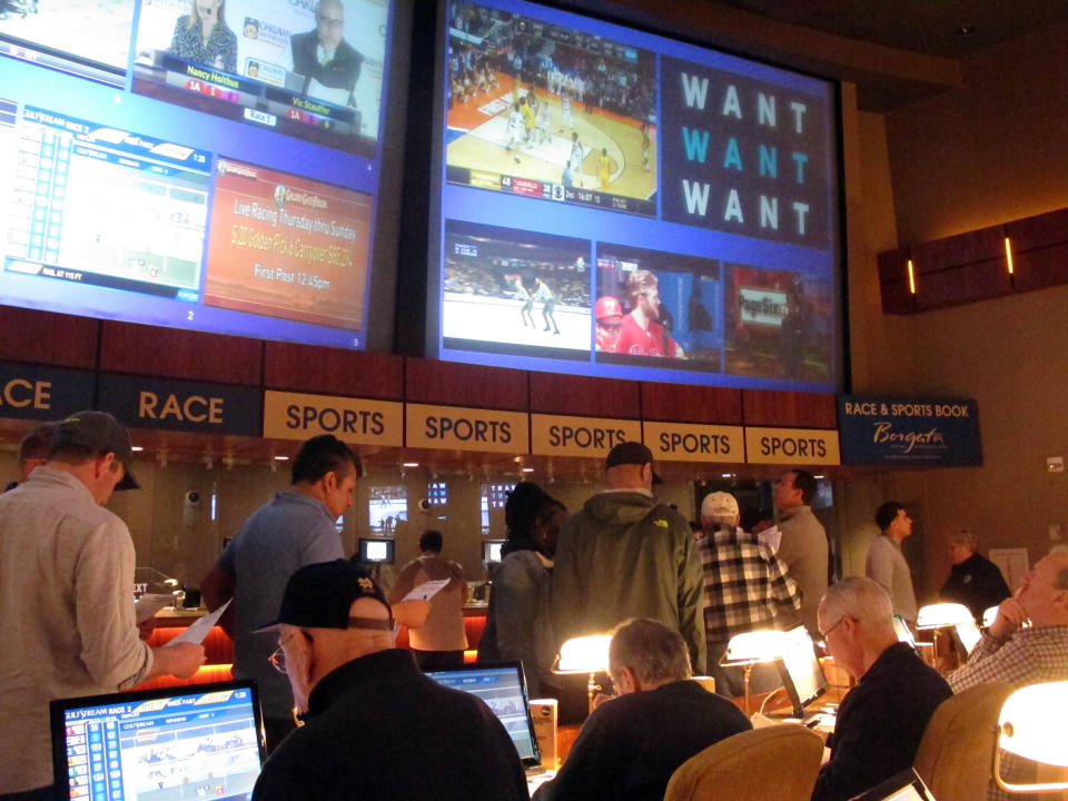Gamblers line up to place bets on the NCAA men's college basketball tournament at the Borgata casino in Atlantic City N.J., Thursday, March 21, 2019. This is the first March Madness tournament since legal gambling expanded last year in the U.S. (AP Photo/Wayne Parry)
