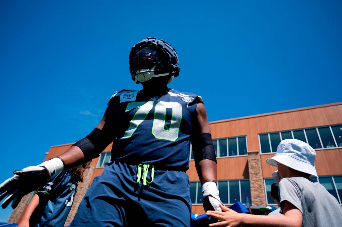 Seattle Seahawks guard Laken Tomlinson (70) gets fans during the first day of training camp at the Virginia Mason Athletic Center, on Wednesday, July 24, 2024, in Renton, Wash.