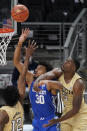 Kentucky forward Olivier Sarr (30) battled Georgia Tech forward Moses Wright (5) for a rebound during the first half of an NCAA college basketball game Sunday, Dec. 6, 2020, in Atlanta. (AP Photo/John Bazemore)