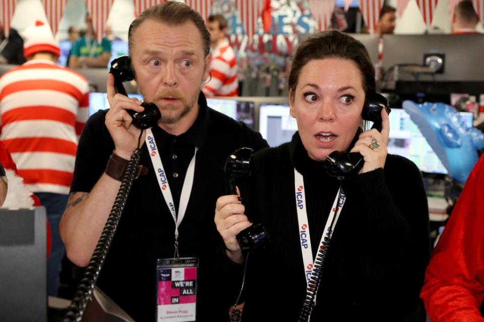 Simon Pegg and Olivia Colman at ICAP headquarters in London during the broker's 29th annual charity day (PA)