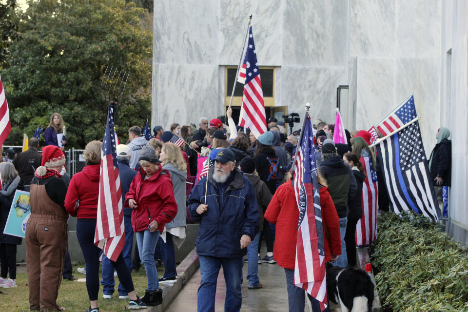 CORRECTS SPELLING TO SELSKY NOT SELSKI Pro-Trump and anti-mask demonstrators hold a rally outside the Oregon State Capitol on Monday, Dec. 21, 2020, as legislators meet for an emergency session. (AP Photo/Andrew Selsky)