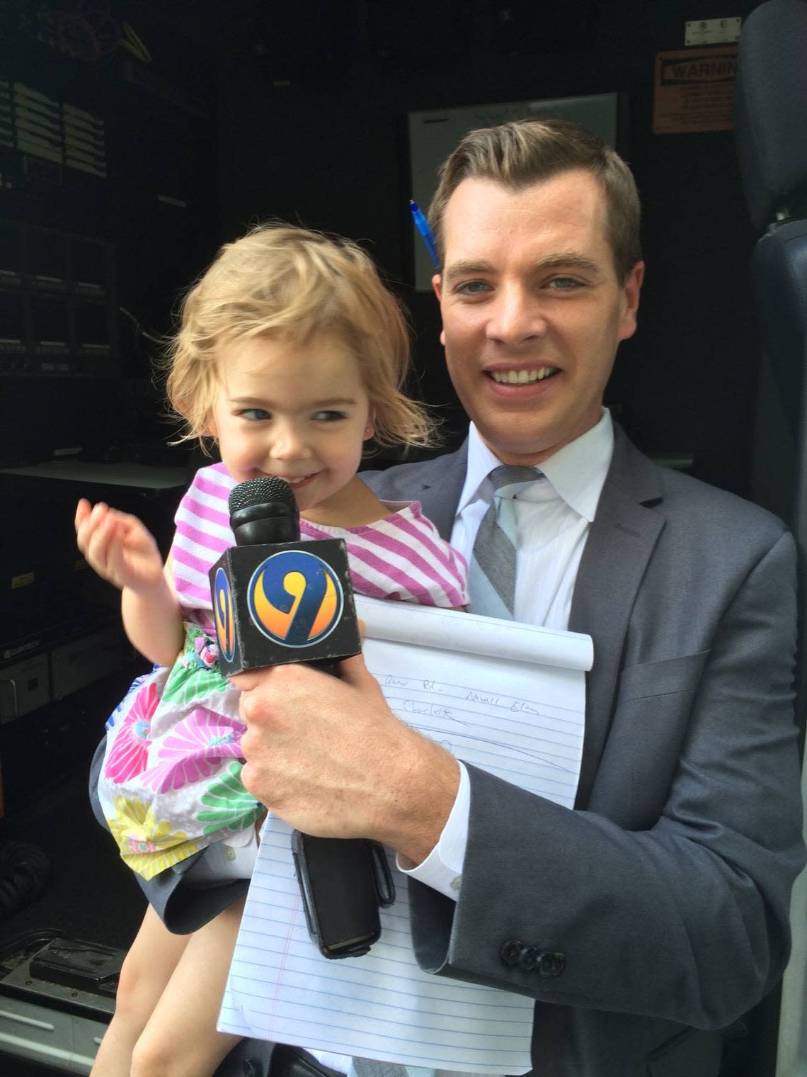 John Paul holds a microphone for one of his daughters not long after he joined WSOC-TV Channel 9 in Charlotte, NC, in 2015. Paul announced on July 25, 2022, that he will be leaving the station for a job in Philadelphia.