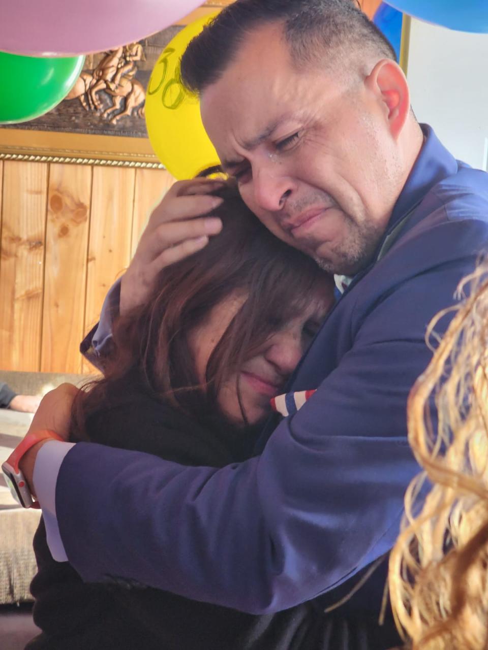 Jimmy Lippert Thyden cries as he holds his mamá, María Angélica González, shortly after their reunion on Aug. 17, 2023, in Valdivia, Chile.