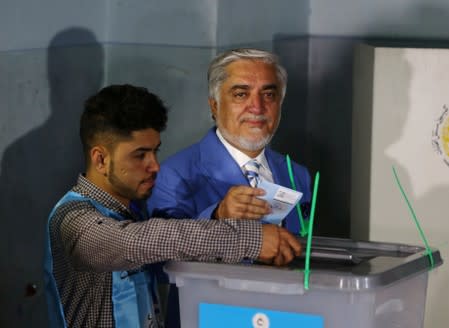 Afghan presidential candidate Abdullah Abdullah casts his vote at a polling station in Kabul