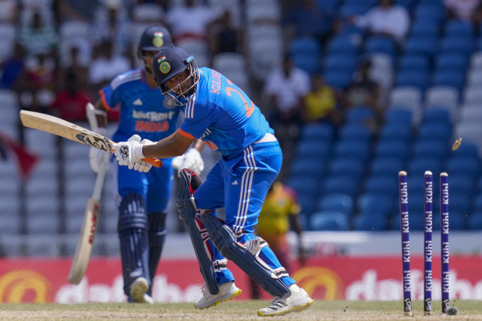 India's Kuldeep Yadav is bowled by West Indies' Romario Shepherd during their first T20 cricket match at the Brian Lara Stadium in Tarouba, Trinidad and Tobago, Thursday, Aug. 3, 2023. (AP Photo/Ramon Espinosa)