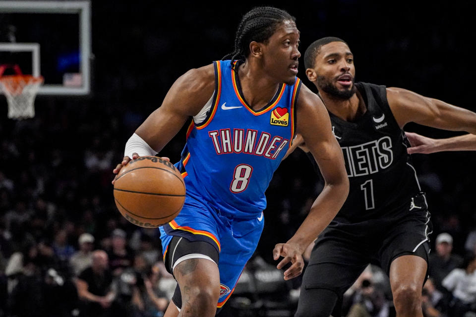 Oklahoma City Thunder forward Jalen Williams (8) drives to the basket next to Brooklyn Nets forward Mikal Bridges (1) during the first half of an NBA basketball game in New York, Friday, Jan. 5, 2024. (AP Photo/Peter K. Afriyie)