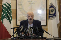 Lebanese Interior Minister Bassam Mawlawi, center, speaks during a press conference about Sunday's parliamentary elections, at the interior ministry in Beirut, Lebanon, Monday, May 16, 2022. Lebanon's militant Hezbollah group and its allies suffered losses in this weekend's parliamentary elections, with preliminary results Monday showing some of their most vocal opponents picking up more seats and several of their traditional partners routed out of the legislature. (AP Photo/Hassan Ammar)