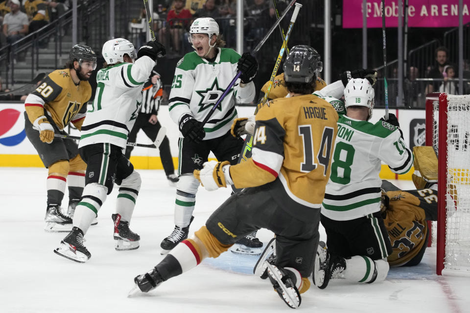 Dallas Stars left wing Joel Kiviranta (25) celebrates after Dallas Stars center Ty Dellandrea, second from left, scored against the Vegas Golden Knights during the third period of Game 5 of the NHL hockey Stanley Cup Western Conference finals Saturday, May 27, 2023, in Las Vegas. (AP Photo/John Locher)