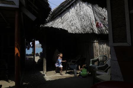 A Guna child plays at her house in Caledonia island in the region of Guna Yala April 4, 2014. REUTERS/ Carlos Jasso