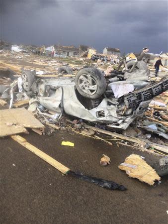 Extensive damage to homes and vehicles is pictured in the aftermath of a tornado that touched down in Washington, Illinois