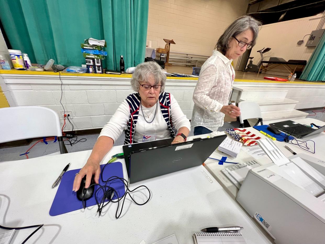 Election workers sign in voters at Holly Oak Park in Shelby on Tuesday, May 17, 2022.