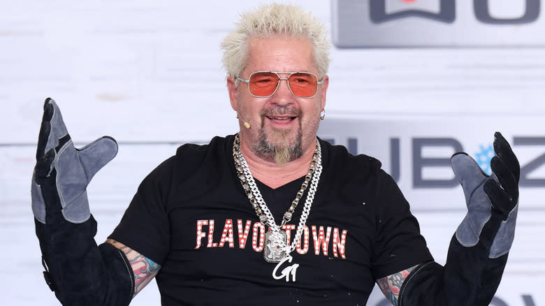 Guy Fieri wearing oven mitts