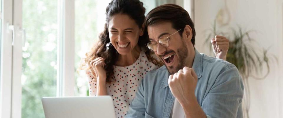 Overjoyed millennial man and woman triumph