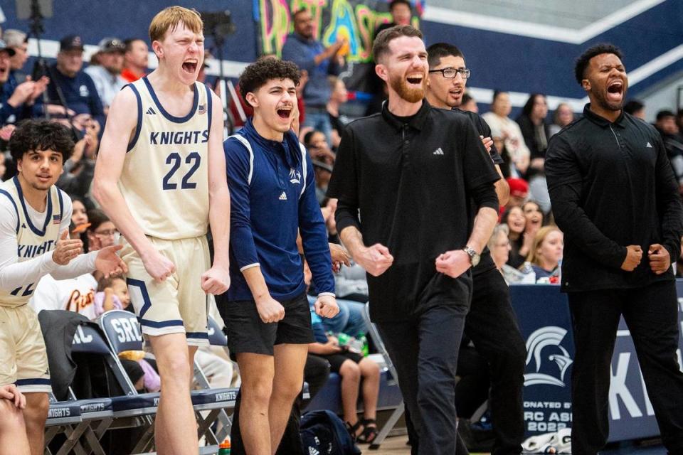 The Stone Ridge Christian bench celebrates a Knight’s basket during a NorCal Regional playoff game against Point Arena at Stone Ridge Christian High School in Merced, Calif., on Wednesday, Feb. 28, 2024. The Knights beat the Pirates 78-67.