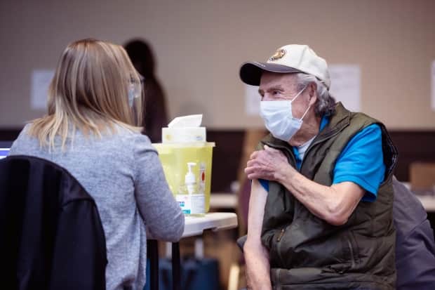 Alberta set a new pace for its vaccine rollout Thursday, administering almost 64,000 doses. The province expanded eligibility this week to everyone over 12.  (Alberta Health Services - image credit)