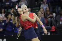 United States' Bethanie Mattek-Sands, right, and Sofia Kenin look to the replay screen to confirm their victory over Latvia's Jelena Ostapenko and Anastasija Sevastova during the doubles match in a Fed Cup tennis qualifying tie, Saturday, Feb. 8, 2020, in Everett, Wash. The U.S. team won the doubles match, and the U.S. advanced in the tourney. (AP Photo/Elaine Thompson)
