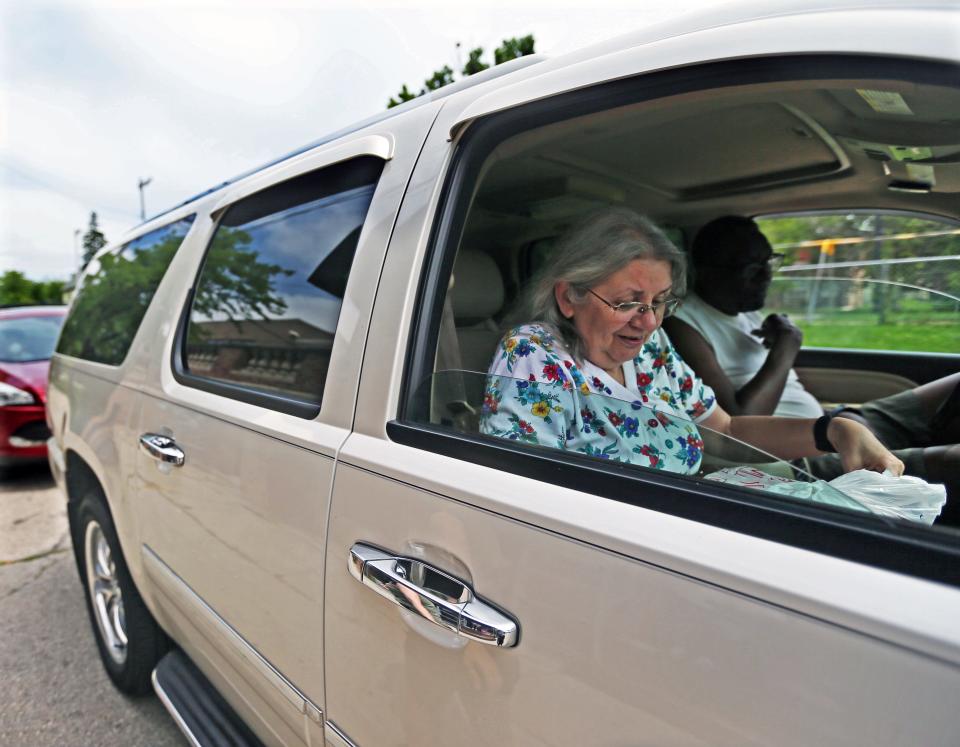 Joy and Charles Wallace of Milwaukee drive up for curbside meals July 19 at Greater Galilee Church, 2432 N. Teutonia Ave. The church is one of the pickup spots for Milwaukee County's Dine Out program, which buys meals from restaurants and gives them to seniors 60 and older.