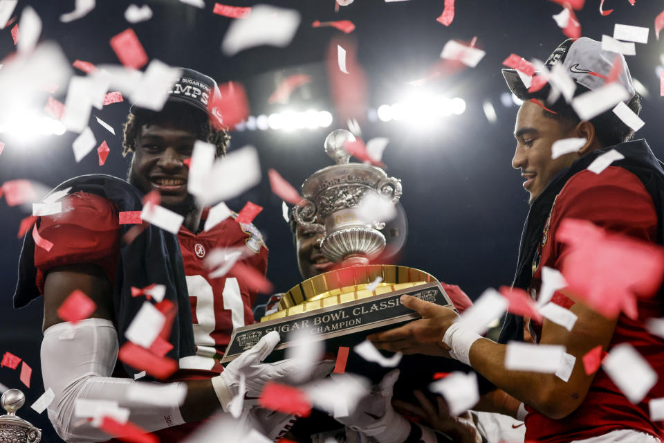 Alabama linebacker Will Anderson Jr., left, defensive back Jordan Battle, center, and quarterback Bryce Young, right, hold the trophy up as they celebrate after the Sugar Bowl NCAA college football game where Alabama defeated Kansas State 45-20, Saturday, Dec. 31, 2022, in New Orleans. (AP Photo/Butch Dill)