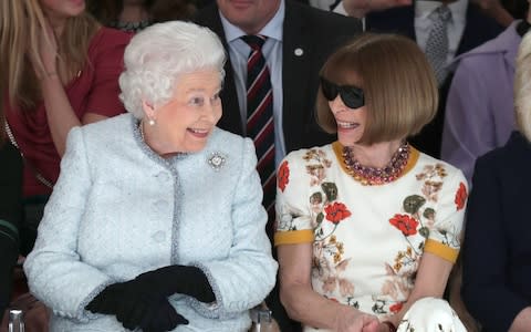 The Queen and Anna Wintour discuss the collection - Credit: PA