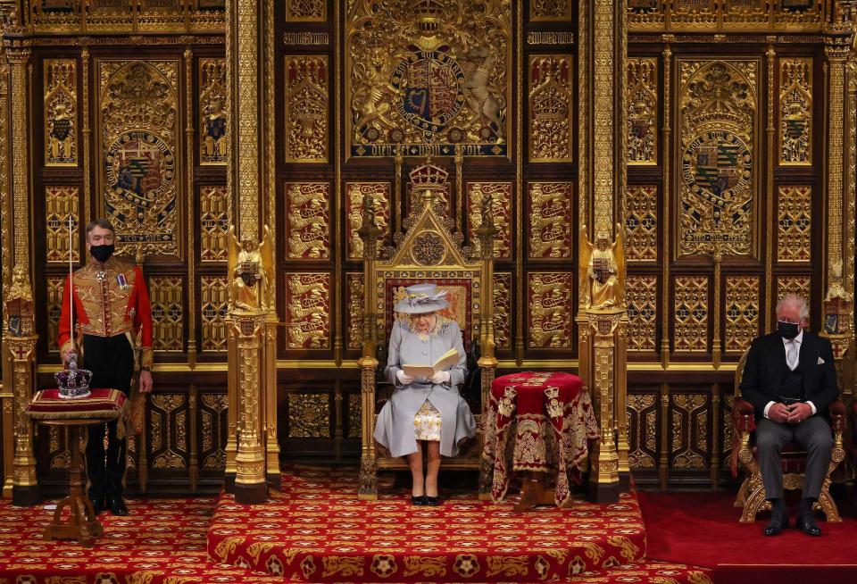 Britain's Queen Elizabeth II reads the Queen's Speech on the The Sovereign's Throne, as Britain's Prince Charles, Prince of Wales listens during the State Opening of Parliament at the Houses of Parliament in London on May 11, 2021. / Credit: CHRIS JACKSON/POOL/AFP via Getty Images