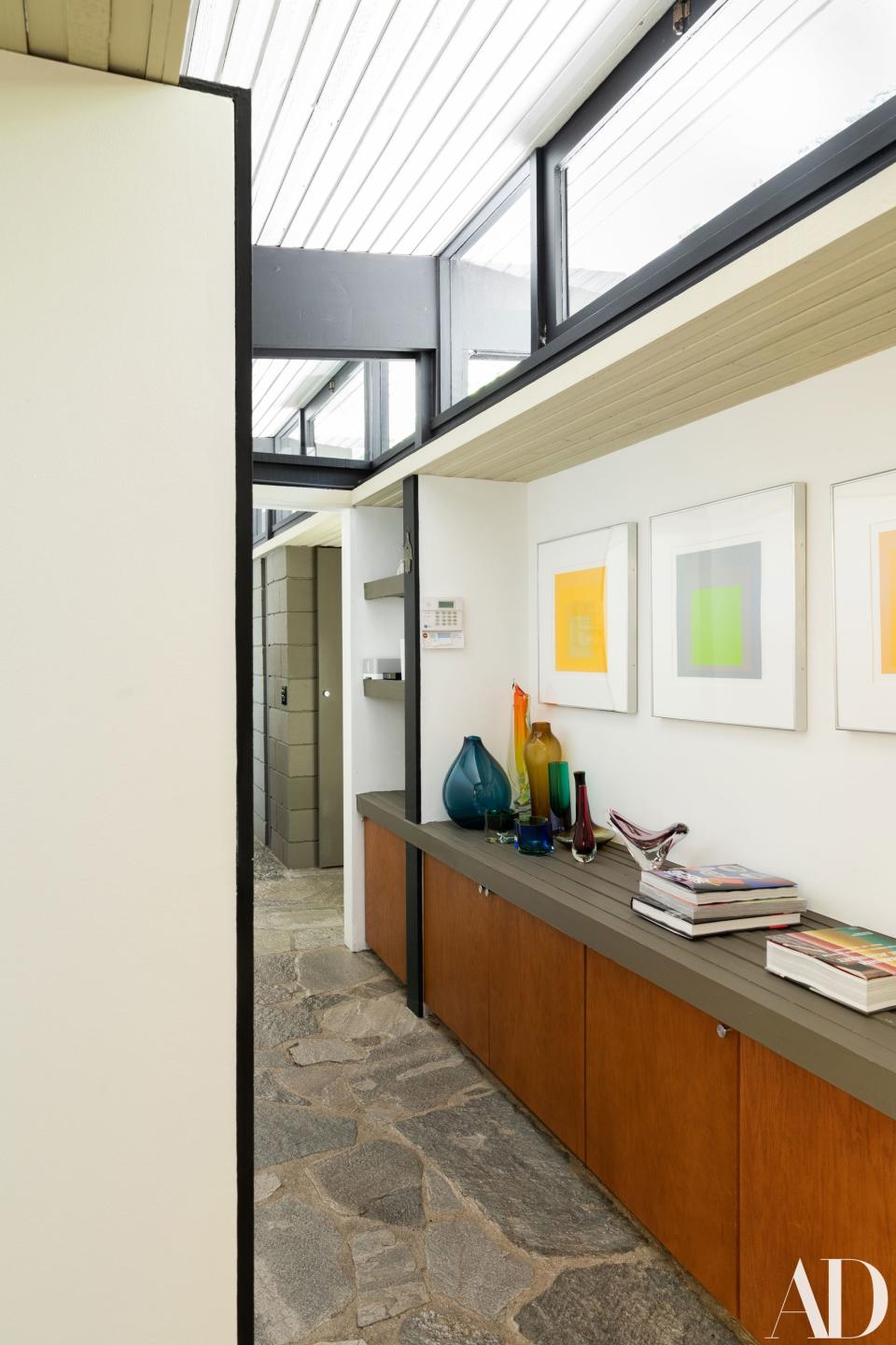 The stone-floored hallway is riddled with books, which the academic-turned-musician collects in a major way, glass sculptures, and vibrant Josef Albers squares. In one of the closets in the house, after moving in, Macklovitch found photocopies of the Los Angeles Times Magazine from August 1955, and the cover was his house, with an article including the floor plans and photos by Julius Shulman.