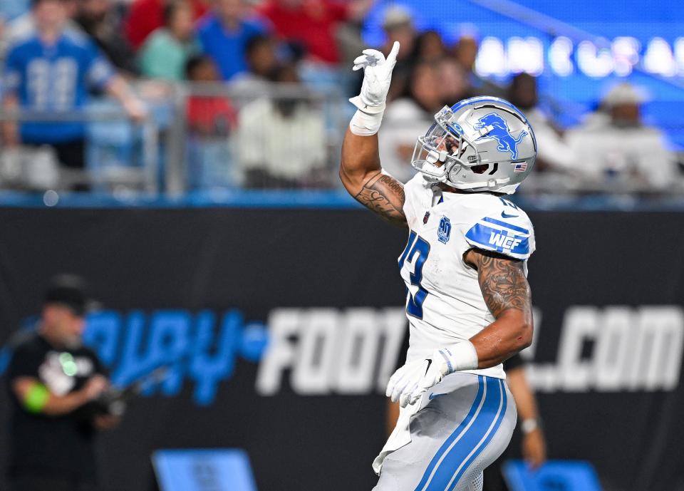 Detroit Lions running back Craig Reynolds reacts after scoring a touchdown against the Carolina Panthers during the first half of a preseason game at Bank of America Stadium on August 25, 2023 in Charlotte, North Carolina.