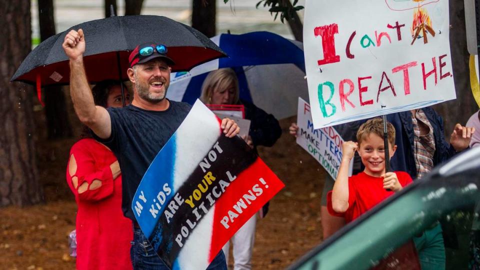 Protesters and counter-protesters demonstrate outside a Wake County Board of Education meeting Tuesday, Aug. 3, 2021 in Cary. The board will vote on a proposal to continue to require face masks in schools. Some parents argue the coverings should be optional.