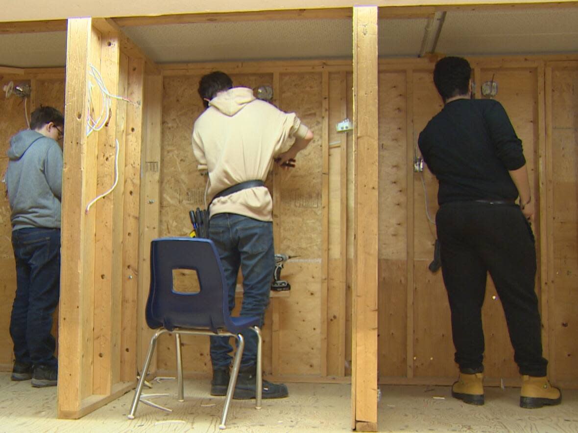 Ontario is facing a generational labour shortage as many skilled tradespeople approach retirement age. Pictured are high school students working on electrical wiring as part of their preparation for possible apprenticeships. (Alexis Raymon/CBC - image credit)