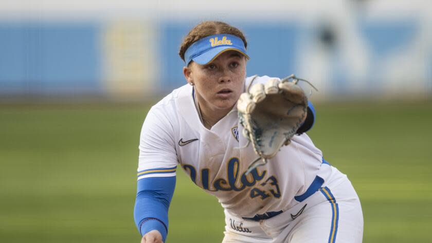 UCLA third baseman Megan Grant (43) catches the ball during an NCAA softball game.