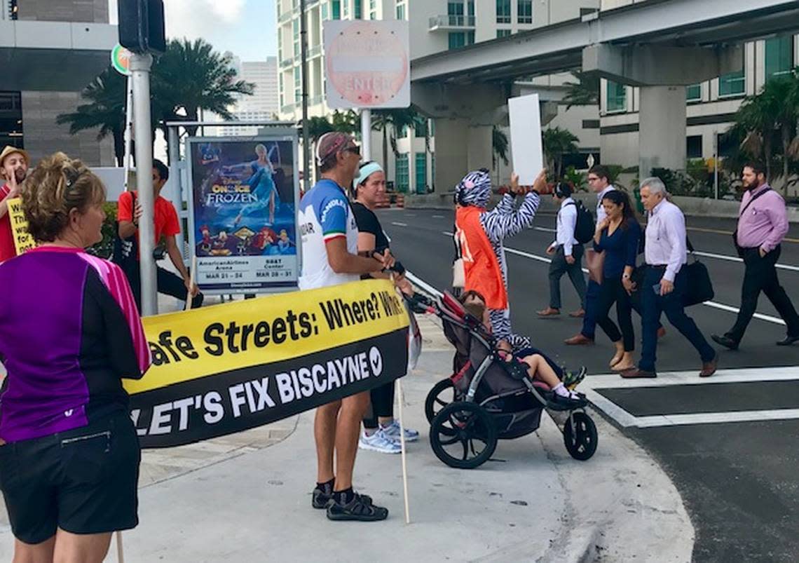 Pedestrians and Miami Transit Alliance protesters at a busy Biscayne Boulevard intersection outside the Safe Streets Summit conference in 2019.