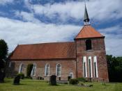 Die Rysumer Dorfkirche ist von sattgrünen Wiesen umgeben - typisch für die Region Krummhörn, die zwischen Emden, Greetsiel und Norden liegt. Foto: www.ostfriesland.de