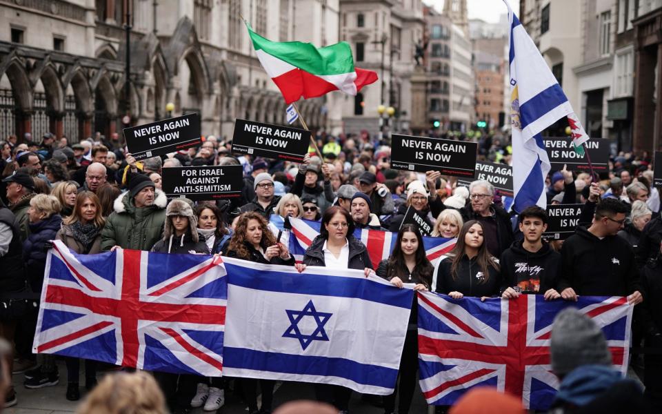 People take part in a march against antisemitism organised by the volunteer-led charity Campaign Against Antisemitism at the Royal Courts of Justice in London