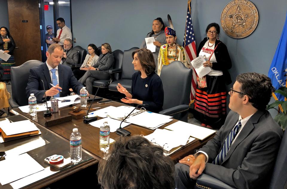 Then-state schools Superintendent Joy Hofmeister speaks while supporters of Sovereign Community School in tribal regalia look on Thursday, Dec. 15, 2022, at an Oklahoma State Board of Education meeting in Oklahoma City.