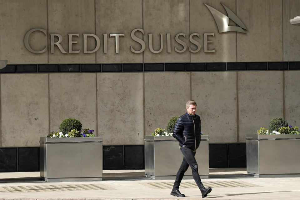 A man walks past the Credit Suisse bank headquarters in London, Thursday, March 16, 2023. Credit Suisse's shares soared 30% on Thursday after it announced it will move to shore up its finances by borrowing up to nearly $54 billion from the Swiss central bank, bolstering confidence as fears about the banking system moved from the U.S. to Europe.(AP Photo/Frank Augstein)