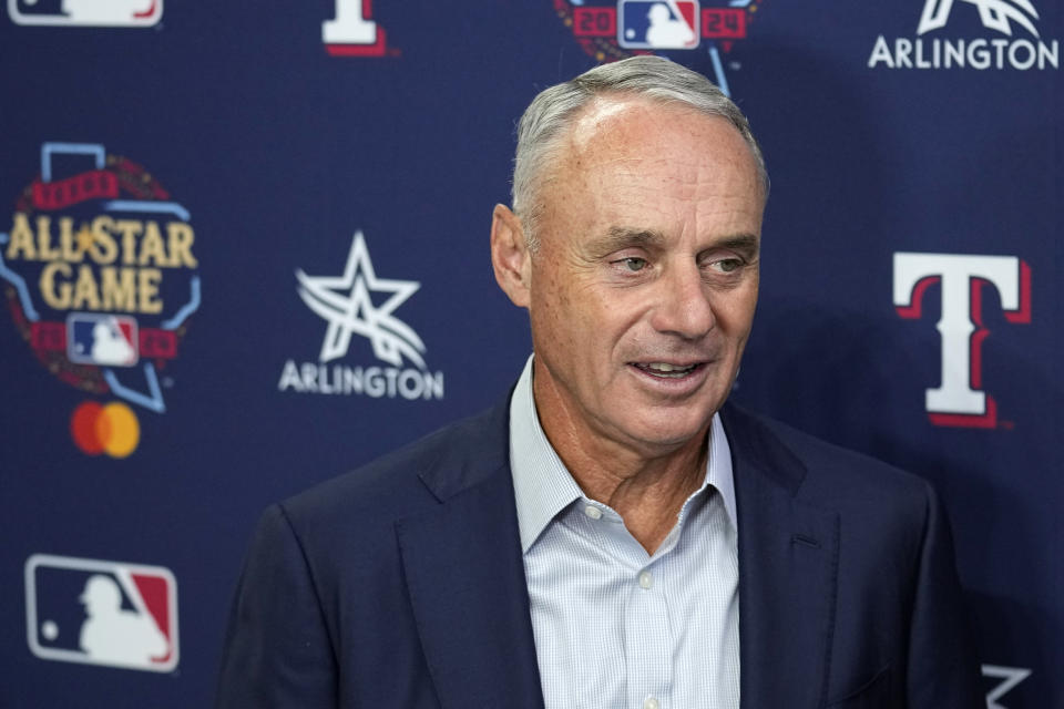 Major League Baseball Commissioner Rob Manfred responds to questions during a news conference after unveiling of the 2024 All-Star game logo, Thursday, July 20, 2023, in Arlington, Texas. The MLB All-Star Game has grown into a truly Texas-sized event since the last time the Rangers hosted the midsummer classic. The countdown is on for 2024 game on July 16, and all of the activities around the game. (AP Photo/Tony Gutierrez)