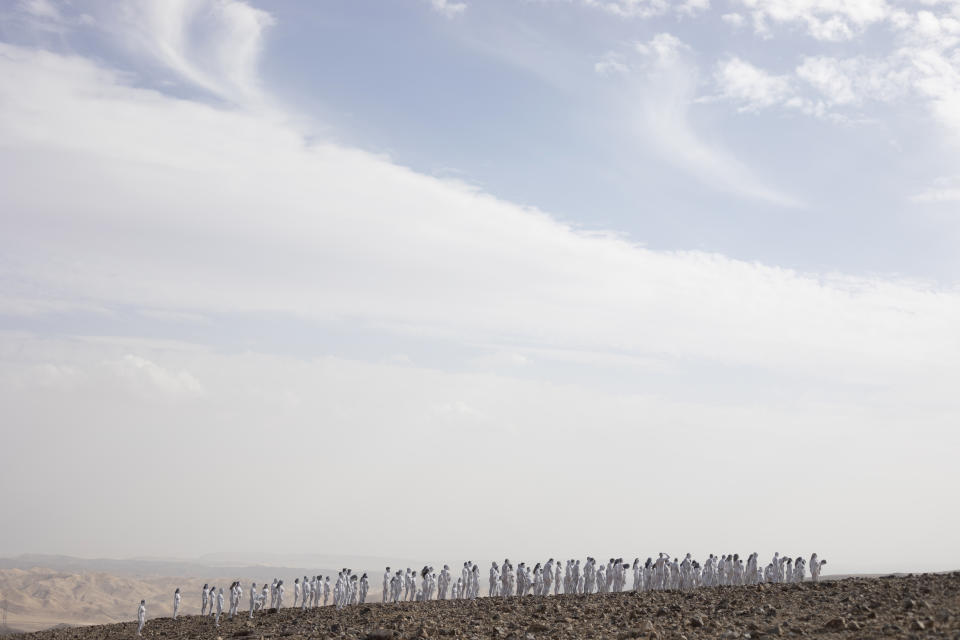 People pose nude for American artist Spencer Tunick as part of an installation in the desert near the Dead Sea, in Arad, Israel, Sunday, Oct. 17, 2021. About 300 participants took part in the nude photo installation designed to draw world attention to the importance of preserving and restoring the Dead Sea. (AP Photo/Ariel Schalit)