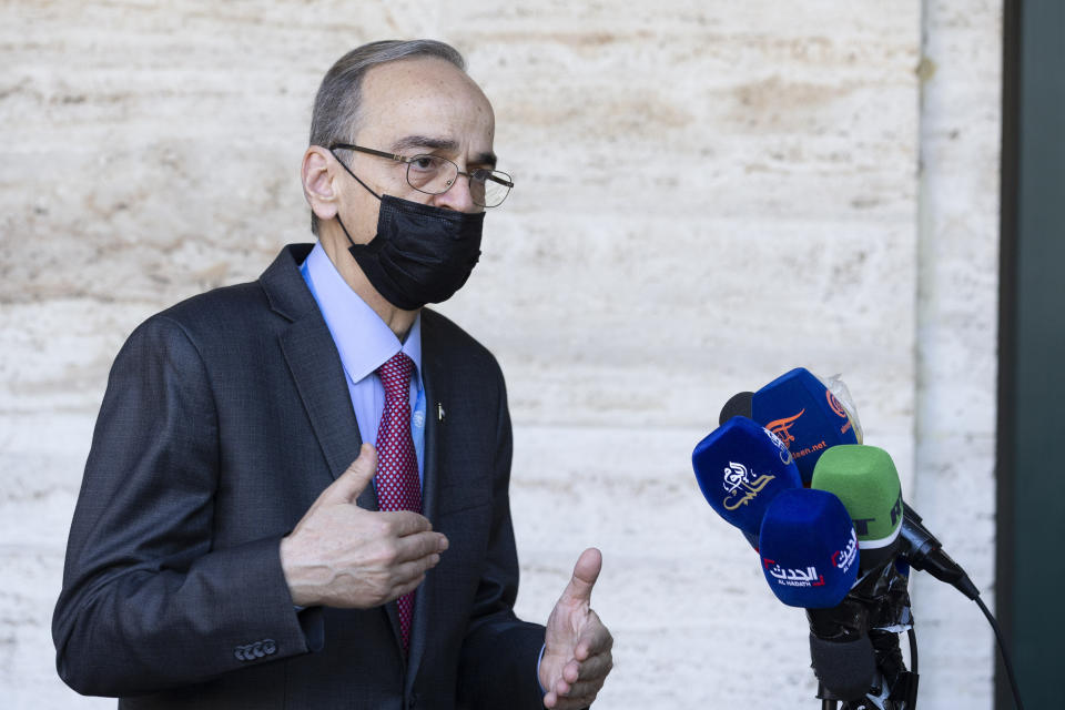 The Constitutional Committee Co-Chair Hadi al-Bahra wearing face mask as precaution against the spread of the coronavirus speaks to reporters following the announcement of the suspension of the conference due to cases of Covid-19, affecting members of one of the delegations, at the European headquarters of the United Nations in Geneva, Switzerland, Monday, Aug. 24, 2020. (Salvatore Di Nolfi/Keystone via AP)