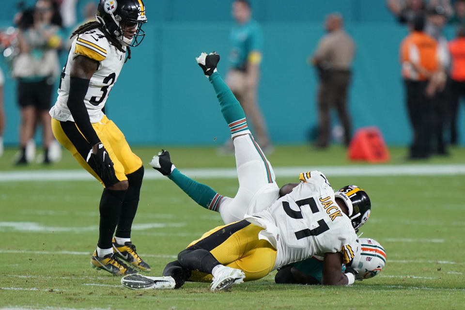 Pittsburgh Steelers linebacker Myles Jack (51) slams Miami Dolphins wide receiver Jaylen Waddle (17) to the ground during the second half of an NFL football game, Sunday, Oct. 23, 2022, in Miami Gardens, Fla. (AP Photo/Wilfredo Lee )