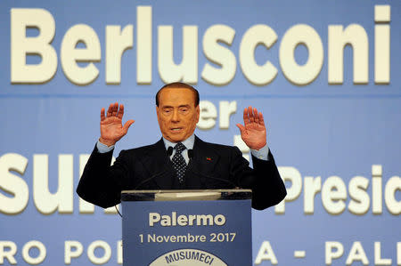 FILE PHOTO: Forza Italia party leader Silvio Berlusconi gestures during a rally for the regional election in Palermo, Italy, November 1, 2017. REUTERS/Guglielmo Mangiapane/File Photo