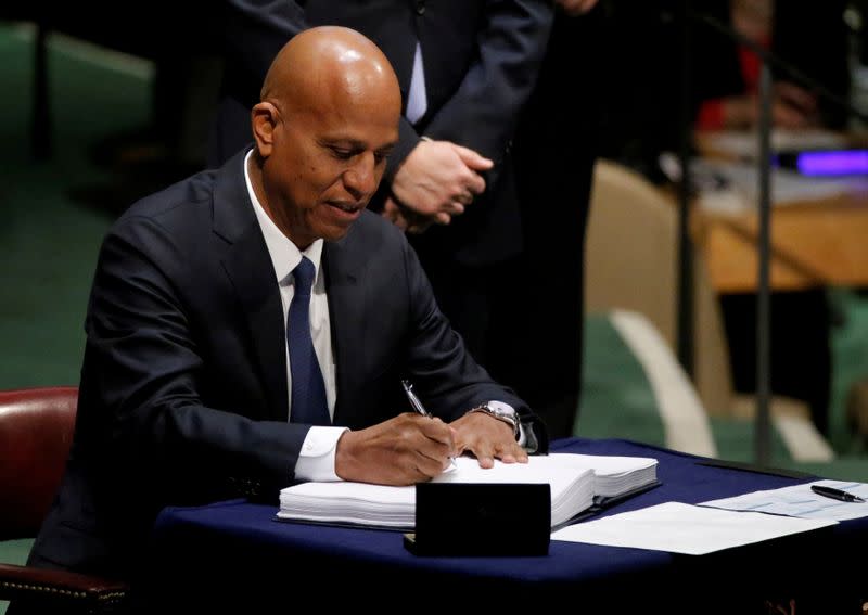 FILE PHOTO: FILE PHOTO: Belize Prime Minister Dean Barrow signs the Paris Agreement on climate change at United Nations Headquarters in New York