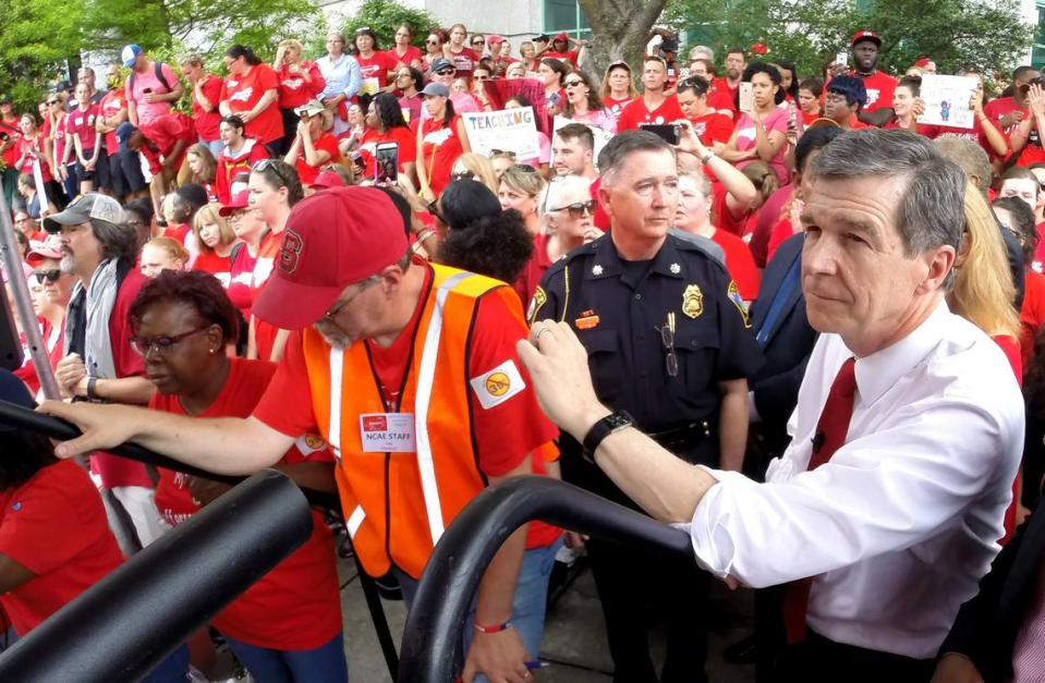 N.C. Gov. Roy Cooper waits to speak as thousands of teachers crowd the Bicentennial Mall in Raleigh in May 2018 during the “March for Students and Rally for Respect,” the largest act of organized teacher political action in state history.
