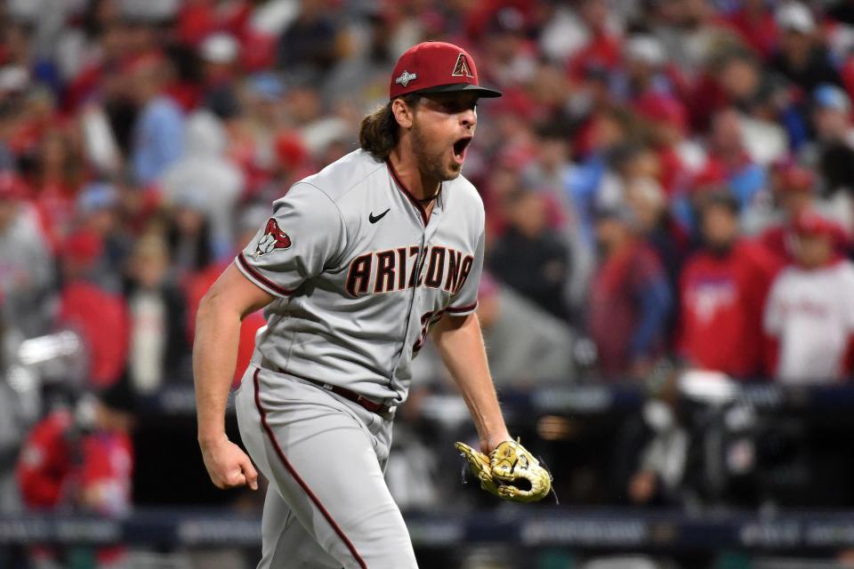 Diamondbacks relief pitcher Kevin Ginkel reacts after striking out the side in the eighth inning.